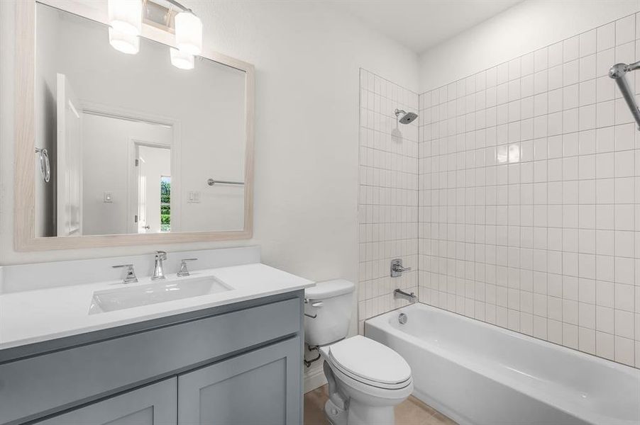 Full bathroom with washtub / shower combination and vanity