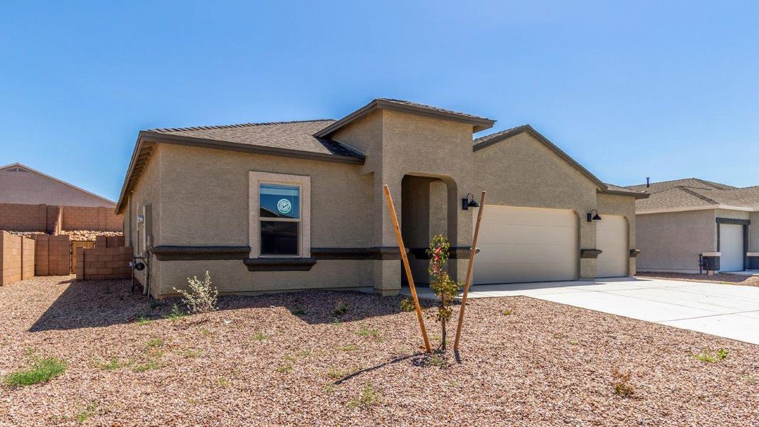 Representative exterior photo of a completed home built from the Cali - Plan H40I by D.R. Horton in Tortolita Trails, Marana, AZ (Image 26).