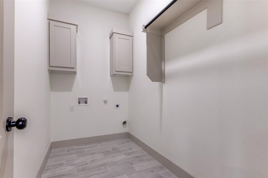 Laundry area with washer hookup, electric dryer hookup, cabinets, and hookup for a gas dryer