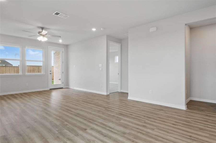Unfurnished living room with ceiling fan, light wood-style floors, and recessed lighting Unfurnished living room with ceiling fan, light wood-style floors, and recessed lighting