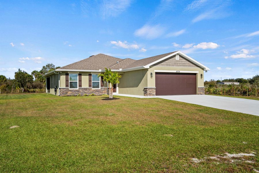 Front exterior of a new home in , Okeechobee, FL, highlighting curb appeal (Image 24).
