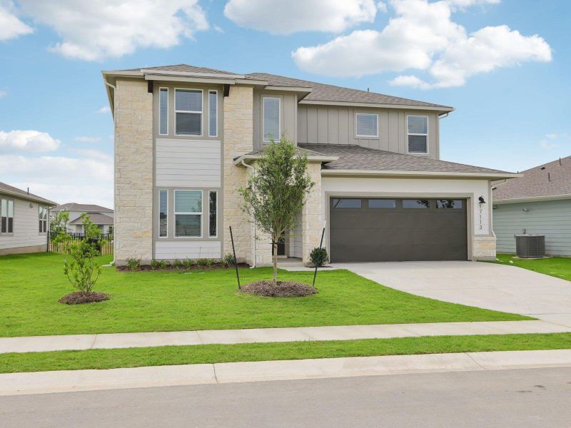 View of front of property with stone siding, central air condition unit, driveway, board and batten siding, and a front lawn View of front of property with stone siding, central air condition unit, driveway, board and batten siding, and a front lawn