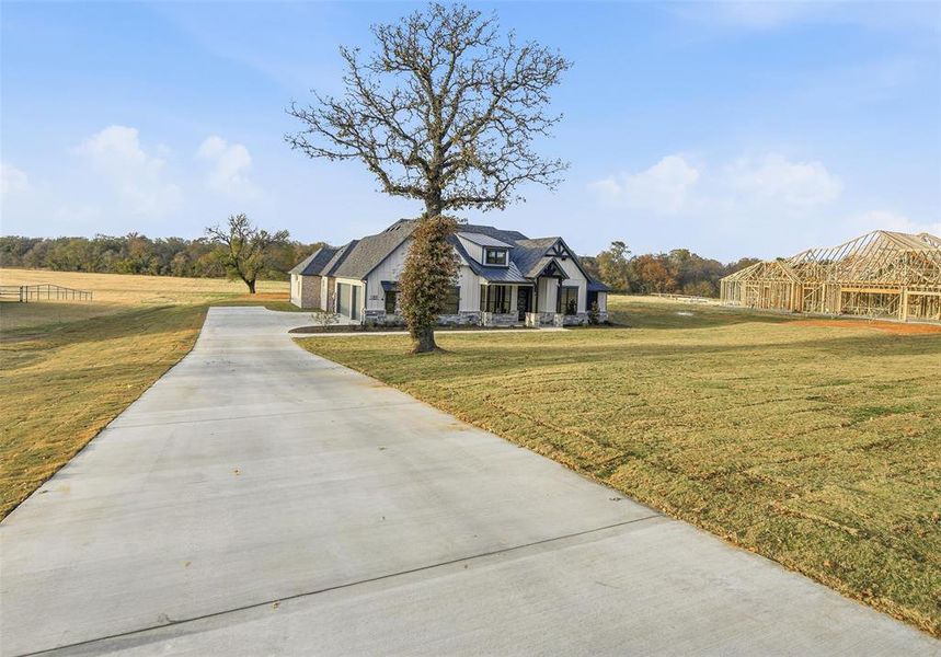 View of front facade with driveway and a front lawn View of front facade with driveway and a front lawn
