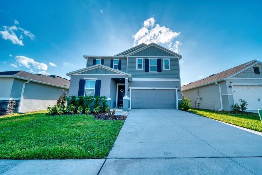 Front exterior of a new home in , Davenport, FL, highlighting curb appeal (Image 26). Front exterior of a new home in , Davenport, FL, highlighting curb appeal (Image 26).