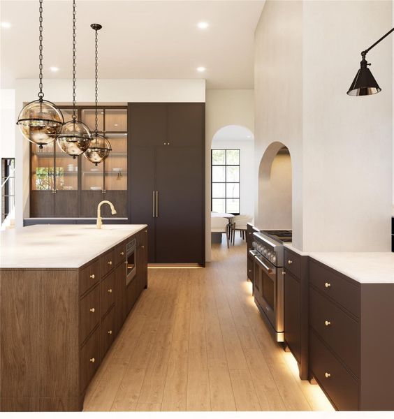 Stunning chef-inspired kitchen showcasing an oversized island, sleek custom cabinetry, sophisticated lighting, expansive storage and open layout design.