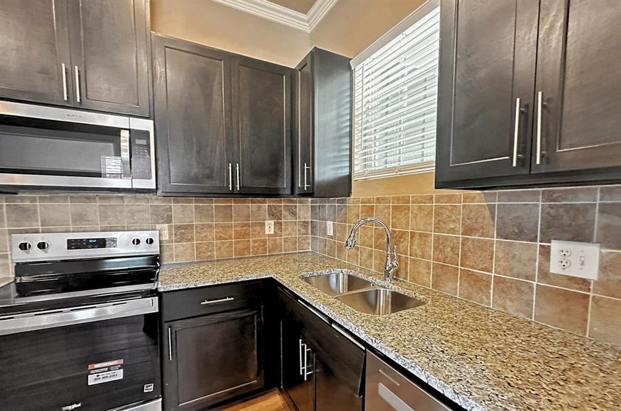 Window over sink, grainte counters, soft close custom cabinets