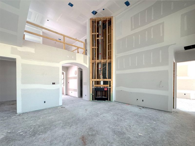 Tall family room with open to below and fireplace surround to the ceiling