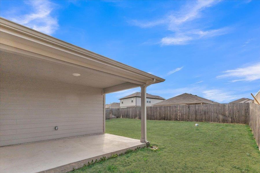 Fenced backyard featuring a patio