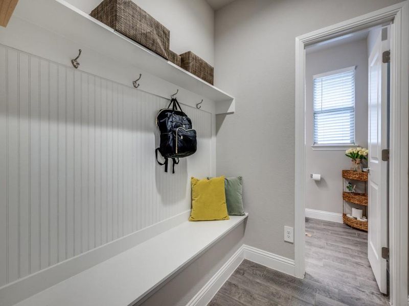 Conveniently located just off the half bathroom, this mudroom offers additional storage and a practical drop zone for daily essentials.