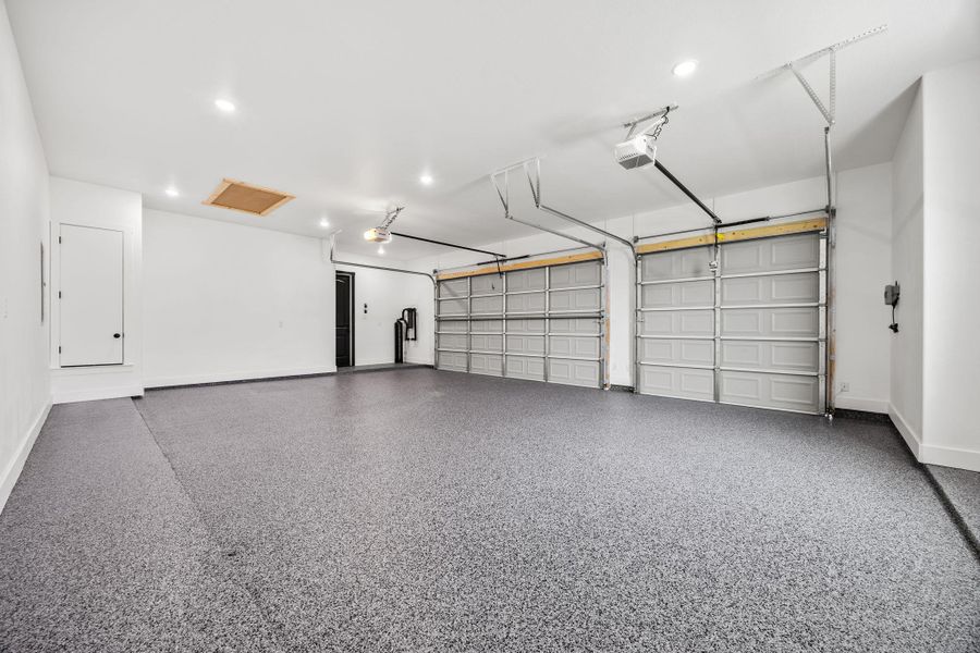 Garage featuring recessed lighting and a garage door opener