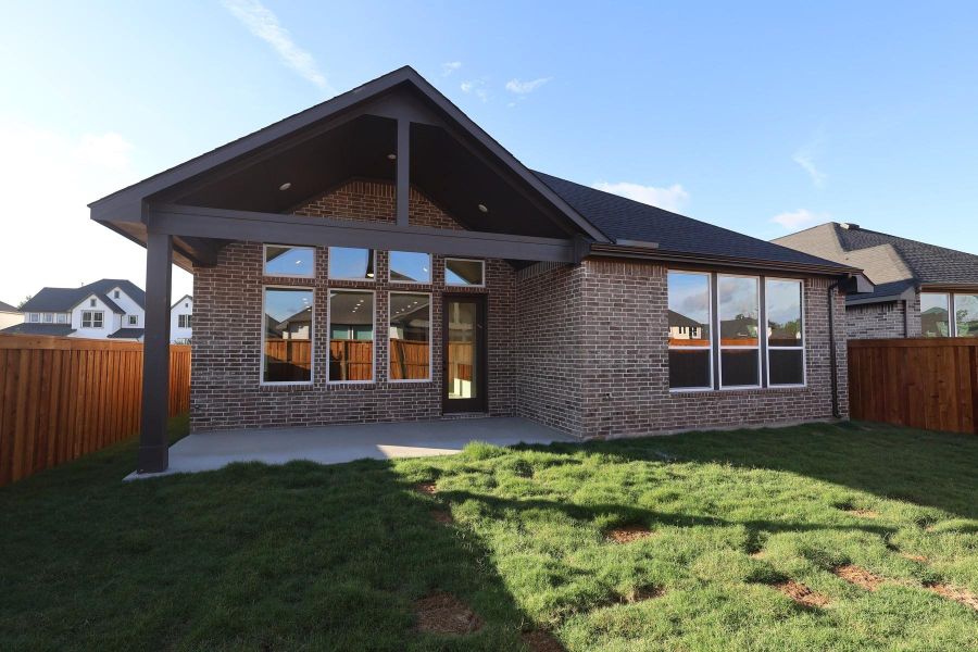 Exterior details and patio area of a home in Woodson’s Reserve, Spring (Image 3).
