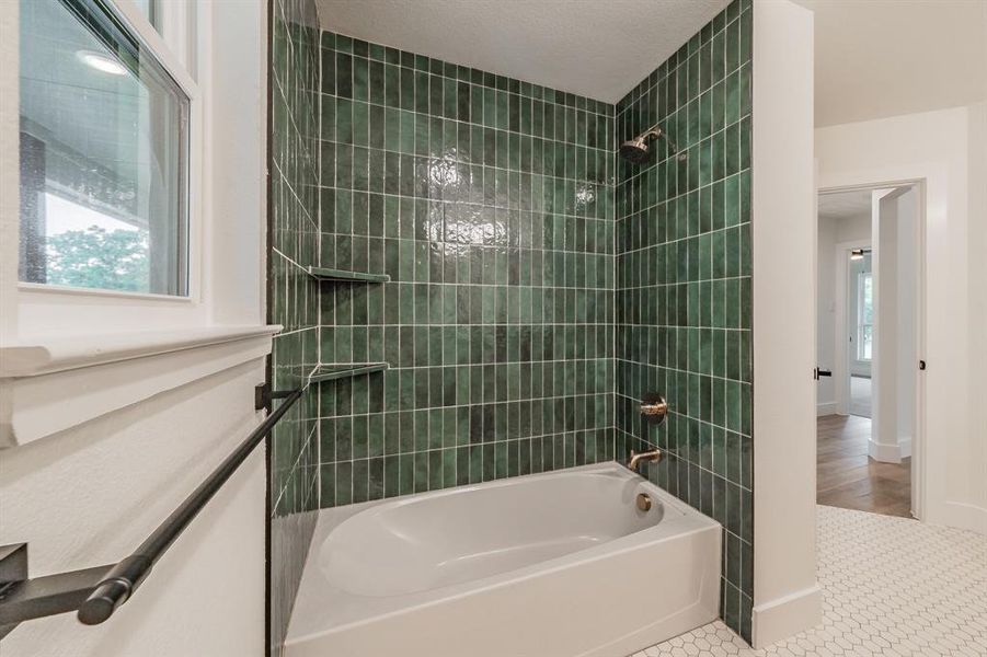 Full bathroom featuring bathing tub / shower combination and baseboards