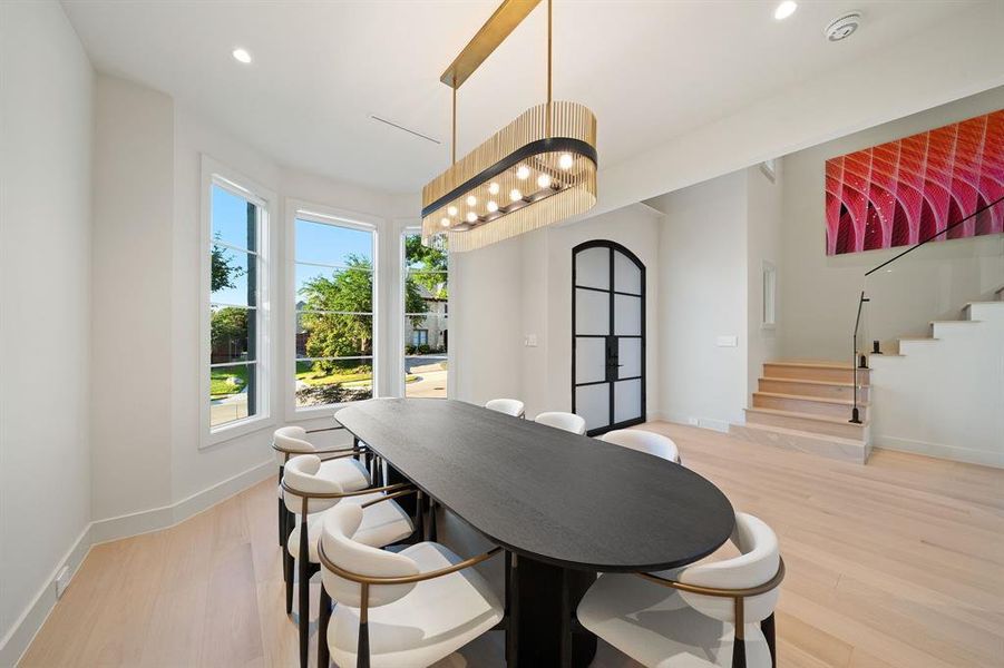 The open floor plan is immediately evident with the dining room flowing to the entry and stairs.  You'll be amazed at the luxury wide-plank flooring in every room!