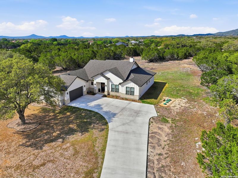 Front exterior of a new home in , Bandera, TX, highlighting curb appeal (Image 27).