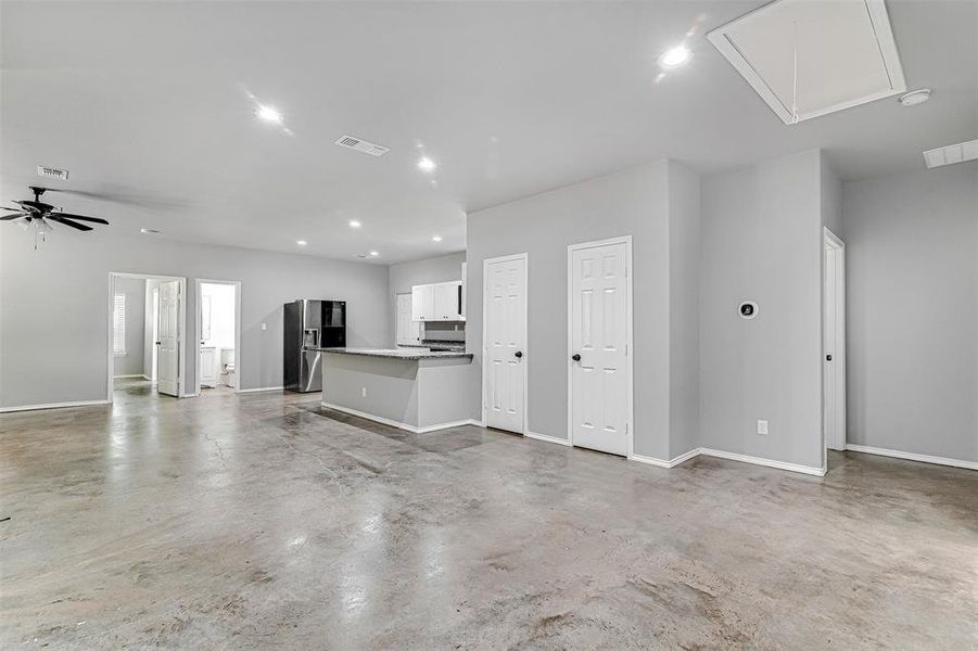 Unfurnished living room with ceiling fan