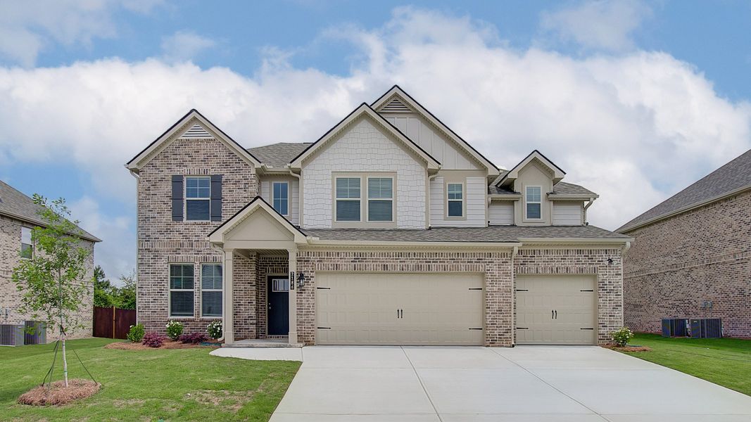 Front elevation of brick single-family home with modern design and landscaped front yard in Dacula, GA.