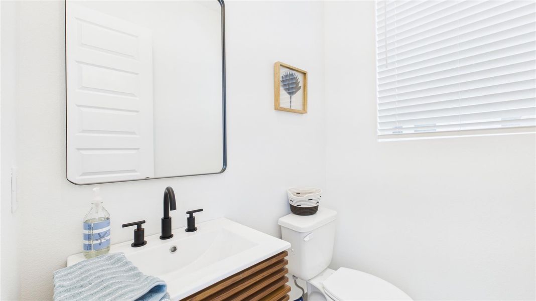 This convenient powder room, located just off the second-floor living area, is perfectly positioned for guests while keeping the bedroom spaces private, offering both functionality and comfort for entertaining.