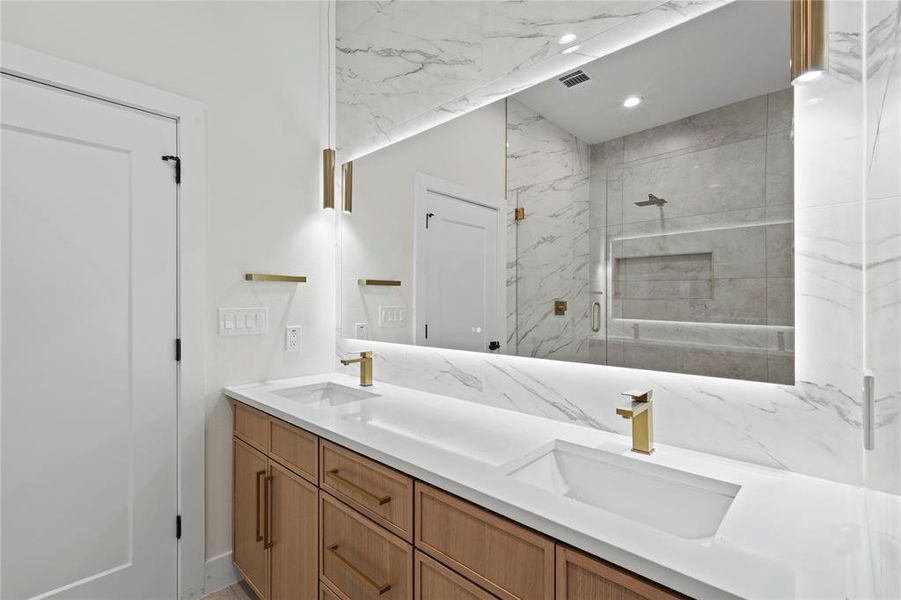 Full bath with recessed lighting, a sink, a shower stall, and double vanity