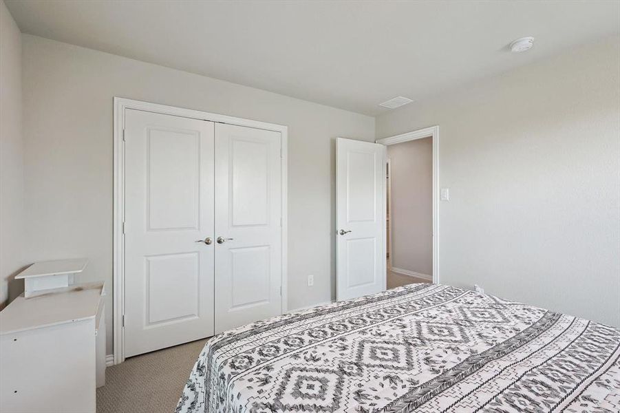 Bedroom featuring a closet and carpet floors