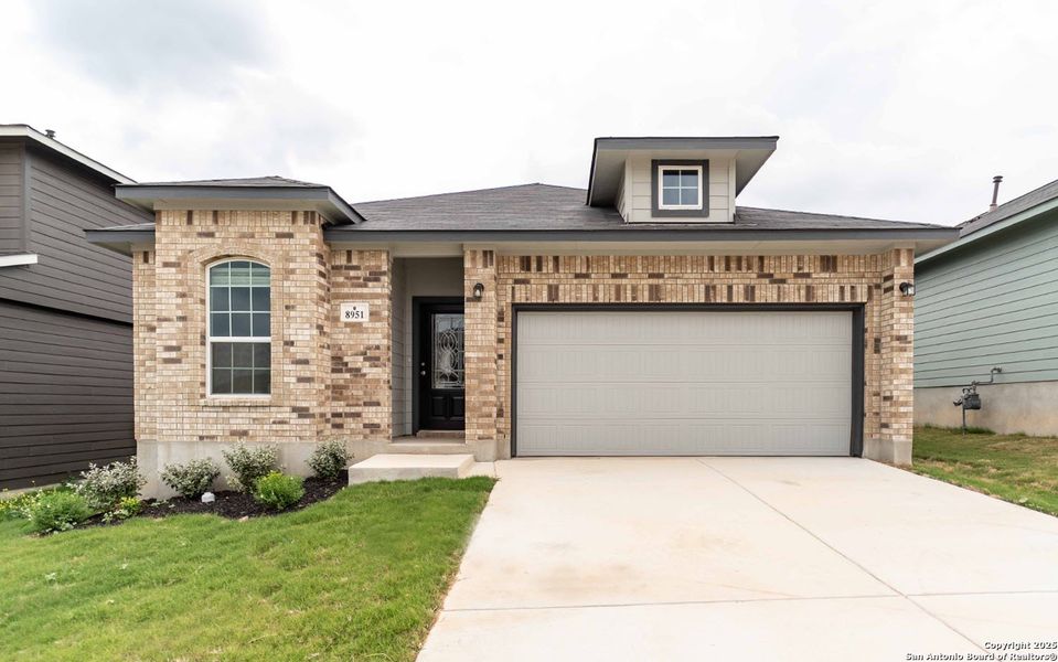 Front exterior of a new home in Hickory Ridge, Elmendorf, TX, highlighting curb appeal (Image 1).