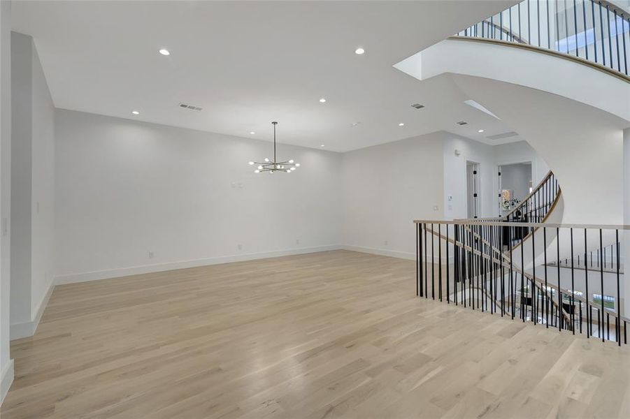 Game  room featuring a chandelier and light hardwood / wood-style floors