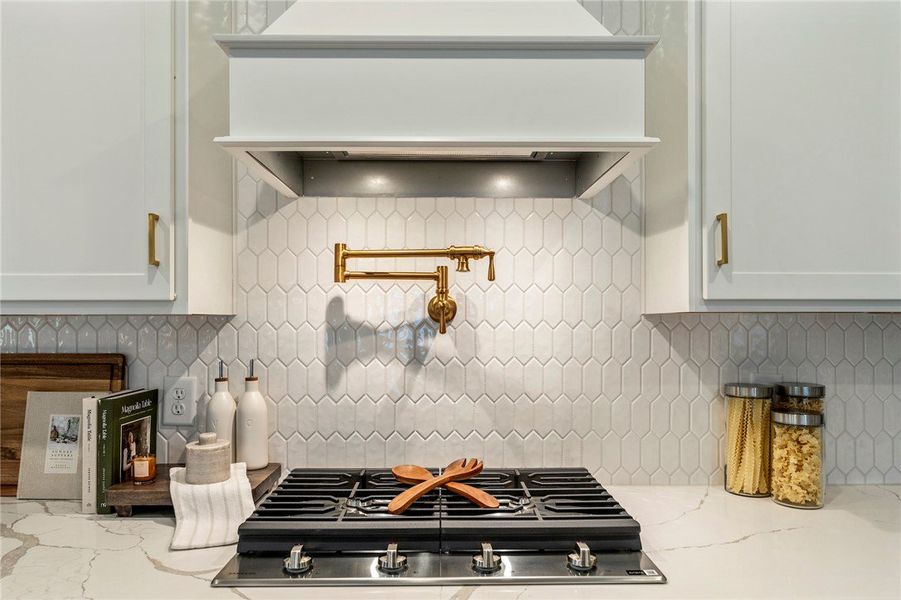 This modern kitchen features a sleek gas cooktop s This modern kitchen features a sleek gas cooktop s