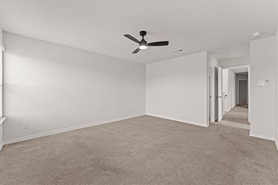 Spare room with light carpet and a ceiling fan Spare room with light carpet and a ceiling fan