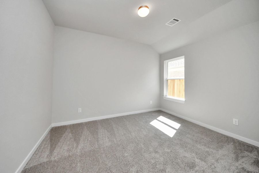 Secondary bedroom features plush carpeting, large windows that let in plenty of natural light, bright paint, and spacious closets. Sample photo of completed home with similar floor plan. Actual colors and selections may vary. Secondary bedroom features plush carpeting, large windows that let in plenty of natural light, bright paint, and spacious closets. Sample photo of completed home with similar floor plan. Actual colors and selections may vary.