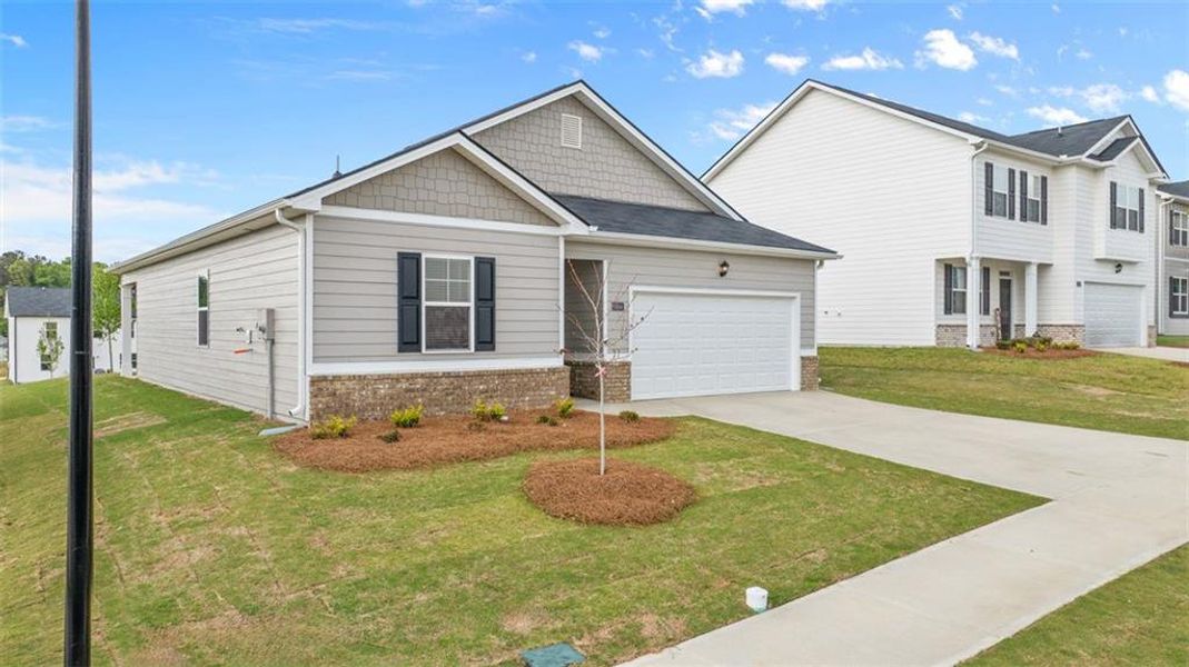 Front exterior of a new home in Champion's Run, Lithonia, GA, highlighting curb appeal (Image 2).