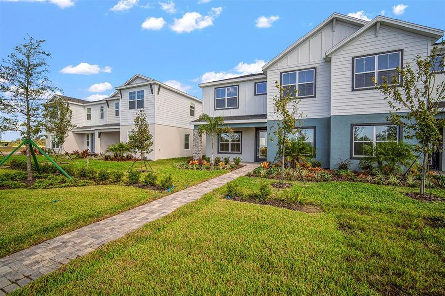 Front exterior of a new home in North River Ranch, Parrish, FL, highlighting curb appeal (Image 26).