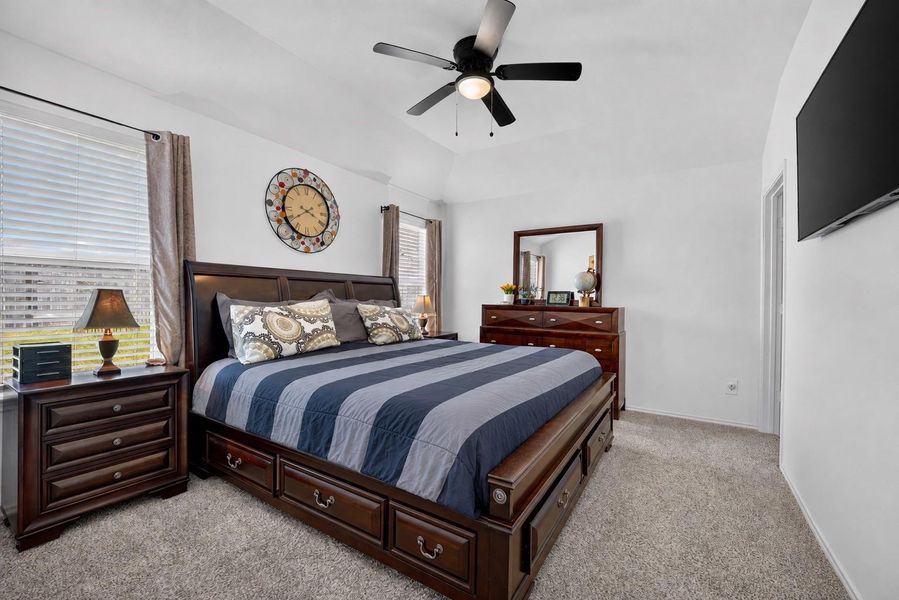 Primary bedroom offers a comfortable retreat with neutral carpeting, ceiling fan and natural light. Primary bedroom offers a comfortable retreat with neutral carpeting, ceiling fan and natural light.