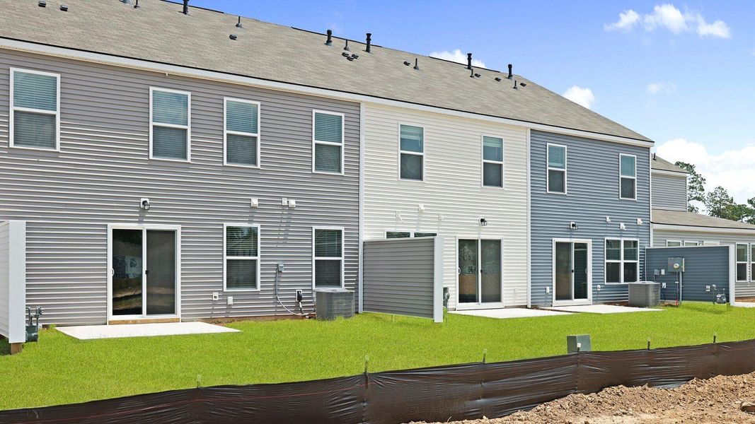 Front exterior of a new home in Pine Hills Townhomes at Cane Bay, Summerville, SC, highlighting curb appeal (Image 17). Front exterior of a new home in Pine Hills Townhomes at Cane Bay, Summerville, SC, highlighting curb appeal (Image 17).
