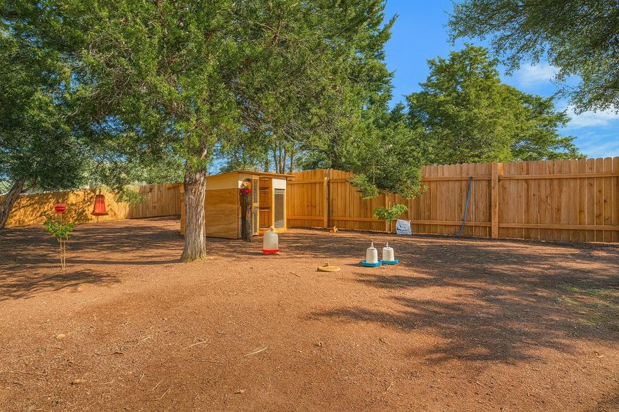 Fenced backyard featuring an outdoor structure Fenced backyard featuring an outdoor structure