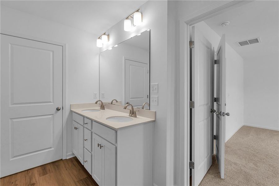 This spacious bathroom features a double vanity an This spacious bathroom features a double vanity an
