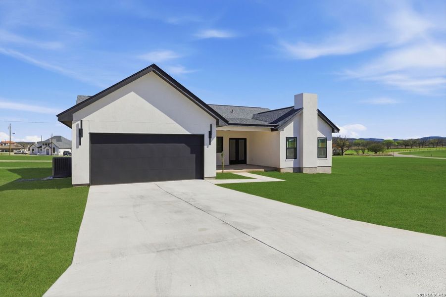 Front exterior of a new home in , Bandera, TX, highlighting curb appeal (Image 27).