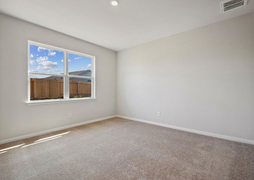 Luxury master retreat with a window overlooking the backyard Luxury master retreat with a window overlooking the backyard