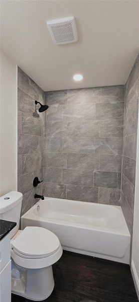 Bathroom with vanity, dark wood finished floors, bathtub / shower combination, and recessed lighting Bathroom with vanity, dark wood finished floors, bathtub / shower combination, and recessed lighting