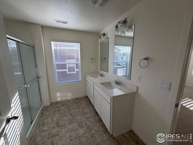 Master bath with double sinks and glass shower doors Master bath with double sinks and glass shower doors