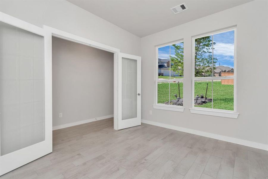 Step into this inviting home office, adorned with premium tile flooring that infuses a sense of freshness and comfort into the workspace. Bask in the natural light pouring through the window, fostering an inspiring environment ideal for productivity and focused work. Sample photo of completed home with similar floor plan. Actual colors and selections may vary.