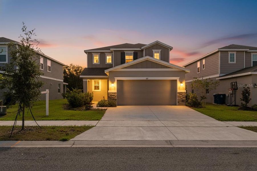 Front exterior of a new home in Seasons at Forest Creek, Haines City, FL, highlighting curb appeal (Image 30).