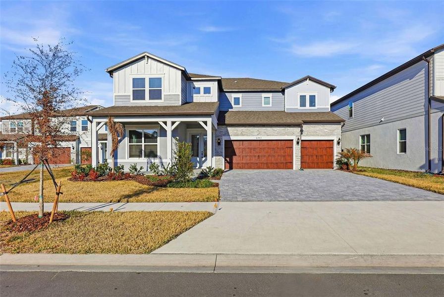 Front exterior of a new home in Vida's Way, Wesley Chapel, FL, highlighting curb appeal (Image 26).