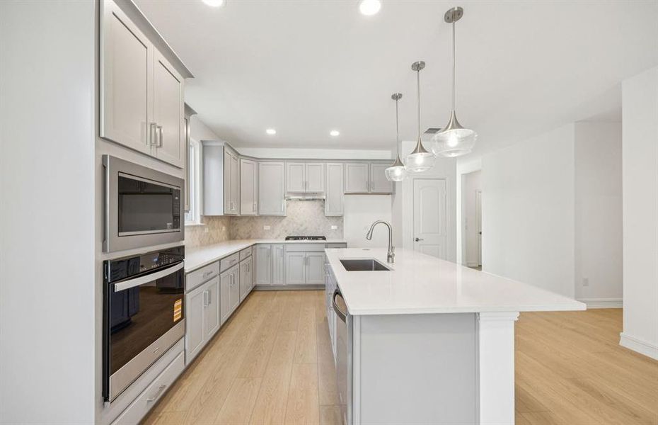 Spacious eat-in island kitchen with pendant lighting and beautiful cabinetry Spacious eat-in island kitchen with pendant lighting and beautiful cabinetry