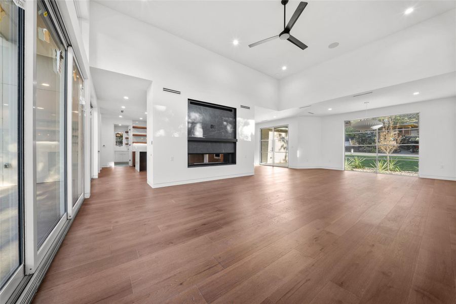 Living room towering ceiling and a double sided fireplace