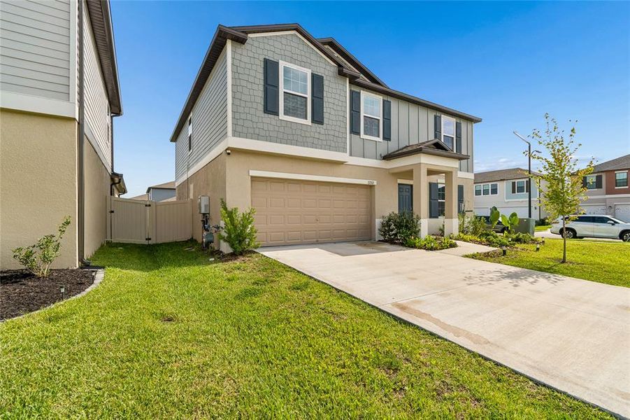 Front exterior of a new home in , Land O' Lakes, FL, highlighting curb appeal (Image 25).