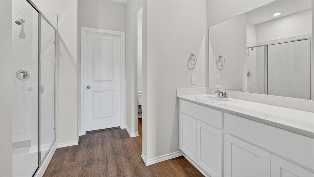 Contemporary bathroom featuring a spacious vanity with white cabinetry, an integrated sink, and a large wall-mounted mirror Contemporary bathroom featuring a spacious vanity with white cabinetry, an integrated sink, and a large wall-mounted mirror