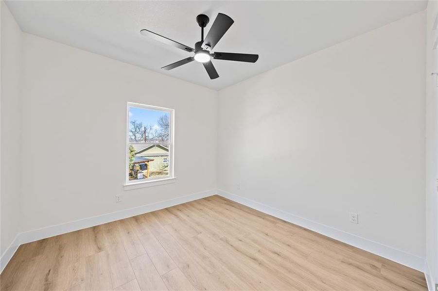 Spare room with light wood-style flooring and ceiling fan Spare room with light wood-style flooring and ceiling fan