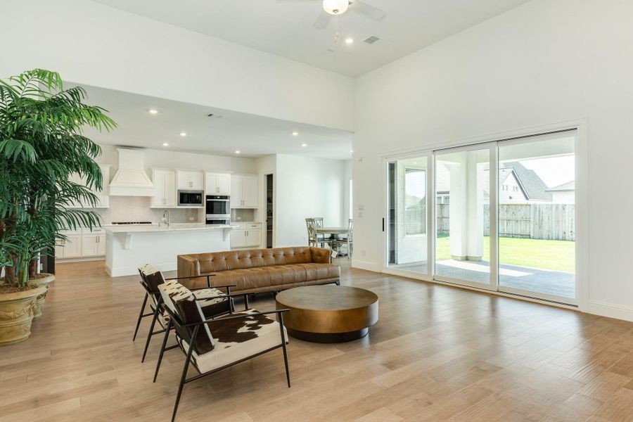 The family room also features triple sliding glass doors that open wide, creating a spacious indoor-outdoor flow perfect for entertaining or relaxing while enjoying the view from your living space.