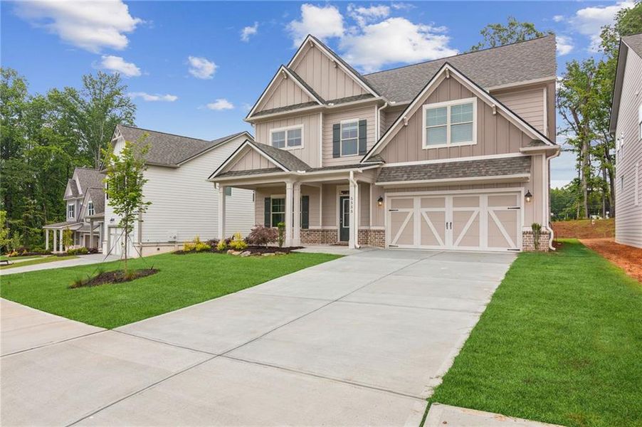 Front exterior of a new home in , Flowery Branch, GA, highlighting curb appeal (Image 1).