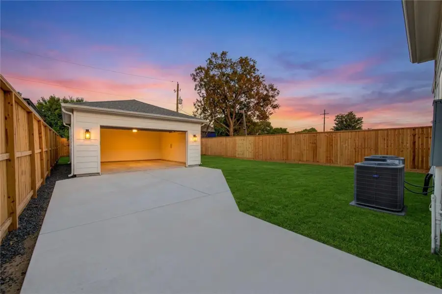 Dusk view of the expansive gated motor court leading to the detached garage, offering exceptional private parking and added flexibility for multiple vehicles. Warm exterior lighting and a dramatic sunset create an inviting approach, while the generous driveway enhances both function and privacy. Dusk view of the expansive gated motor court leading to the detached garage, offering exceptional private parking and added flexibility for multiple vehicles. Warm exterior lighting and a dramatic sunset create an inviting approach, while the generous driveway enhances both function and privacy.