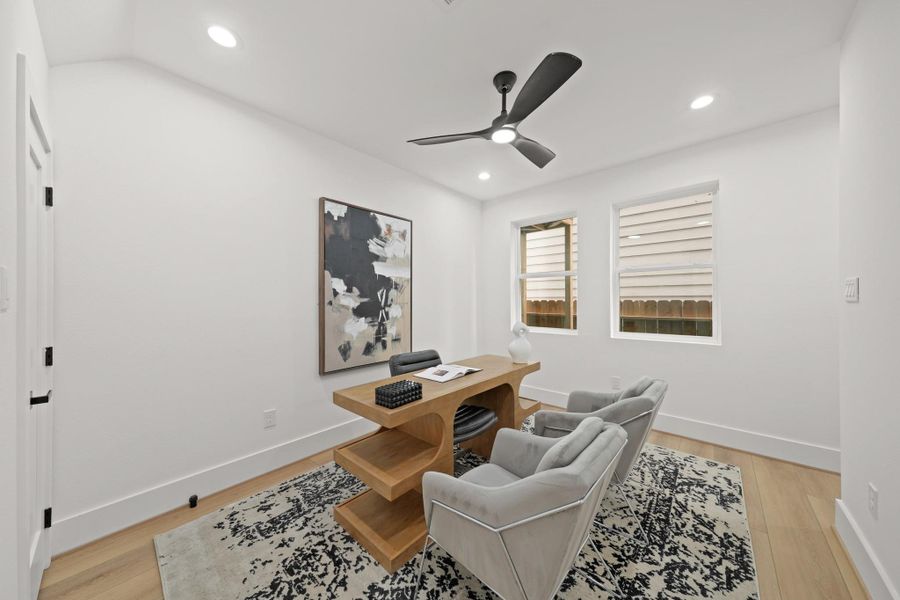 Located just off the foyer on the first floor, the third bedroom with ensuite bath has luxury vinyl planked floors, recessed lights, a ceiling fan with integrated light, large windows and a spacious walk-in wardrobe closet.